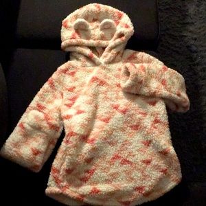 a pink fuzzy sweatshirt with cat ears.